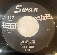 A-side label showing Swan logo, "She Loves You", catalogue S-4152-S, "DON'T DROP OUT" text, runtime 2:18