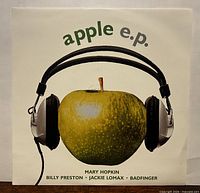 Front picture sleeve showing apple with headphones