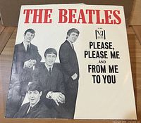 Front of VJ picture sleeve showing The Beatles photo and titles