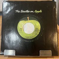 Front of black company sleeve with record partially visible through center hole