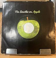 Front of black company sleeve showing record center label through die-cut