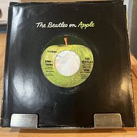 Record in black 'The Beatles on Apple' company sleeve front view