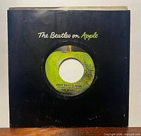 Front view of record in black "The Beatles on Apple" sleeve