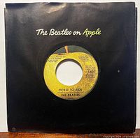 Front view of 7" single in black "The Beatles on Apple" sleeve