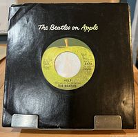 Record in black The Beatles on Apple company sleeve, label visible through cut-out