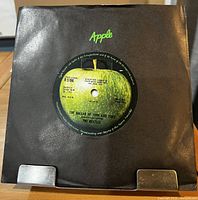 Front view of 7" single in black Apple sleeve
