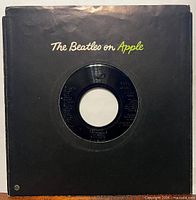 Front of black die-cut sleeve with record partially visible
