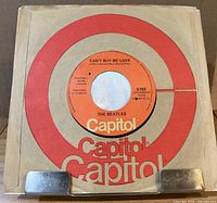 Record in white stock sleeve showing orange Capitol label through center, catalogue 5150