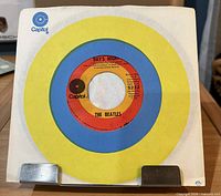 Front view of record in Capitol sleeve showing label through center cutout