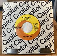 Front of 7" single in Capitol logo sleeve showing A-side label