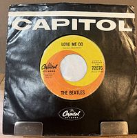 Front view of record in black Capitol sleeve showing label through center hole