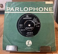 Front of green Parlophone sleeve with record visible