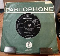 Green Parlophone sleeve holding record
