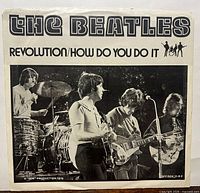 Front of picture sleeve with live performance photo and titles