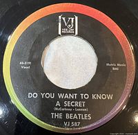 A-side label showing title, artist, catalogue number, rainbow label design, ink stamp