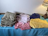 Overview of five fabric stacks in khaki, pink, lavender, purple and yellow