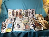 Full lot of assorted sewing patterns displayed on blue backdrop