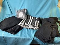 Overview of all fabric pieces on blue surface