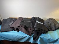 All folded fabric pieces laid out together on blue surface