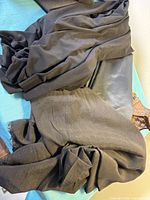 Stack of folded black fabrics showing different textures