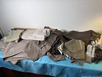 Pile of assorted neutral fabrics showing variety of colors and textures