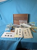 overview of wooden box, zip bags of buttons, and three sample cards
