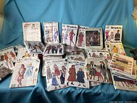 Full spread of sewing pattern envelopes on blue background