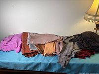 Pile of multicoloured fabric pieces on surface