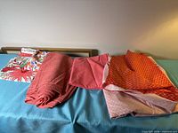 Five folded fabrics displayed on blue table
