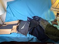 Wide view of assorted dark fabric pieces on sofa