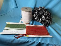 overall view of elastic roll, cards of trims, black & white trim bundle