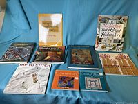 All nine books arranged on blue cloth