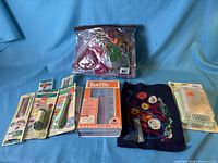 Entire lot laid out: Walnut Hollow box, Clover packs, wool bag, sample piece, foam mat