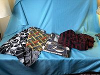 All four folded fabric pieces on blue backdrop