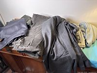 Stack of various grey fabrics on cabinet