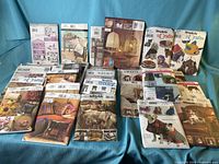 Overview of all packaged sewing patterns spread on blue cloth