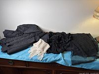 Overview of all folded lace pieces on dresser