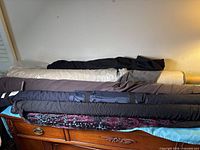 Multiple fabric bolts laid out on dresser