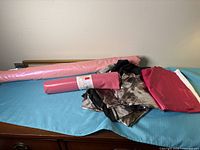 Overall lot showing pink vinyl bolt, smaller pink roll, metallic bronze pieces and fuchsia sheet
