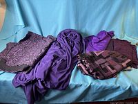 Overview of five purple fabric pieces on blue background