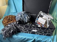 Lot overview with three ribbon hanks, thread bag, storage box