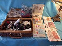 overall lot with basket, bag of zippers, thread cones, patterns