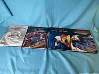Four Singer sewing series hardcover books laid out