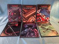Front covers of all six Singer sewing books