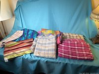 All six folded fabric pieces on blue backdrop