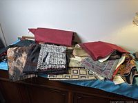 Overall view of mixed fabric swatches stacked on cabinet