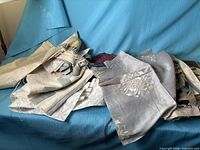 Pile of various fabric remnants on blue surface