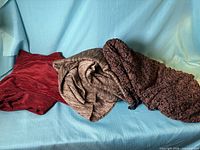 All three fabric pieces laid out on sofa