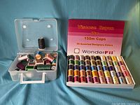 Overview of WonderFil box and plastic case with spools