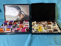 Both open cases showing all thread spools